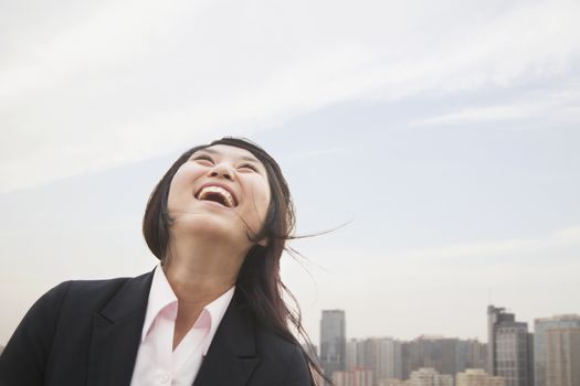 Young businesswoman smiling with hair blowing