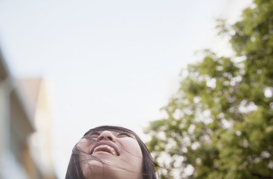 Young woman smiling with hair blowing