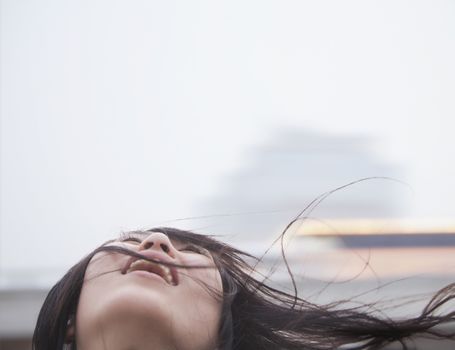 Young woman with hair blowing