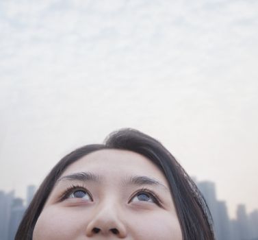 Young woman looking up