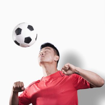 Footballer heading the ball, white background