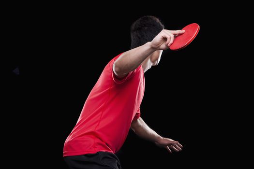 Man playing ping pong, black background