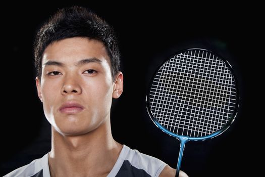 Man with badminton racket, portrait