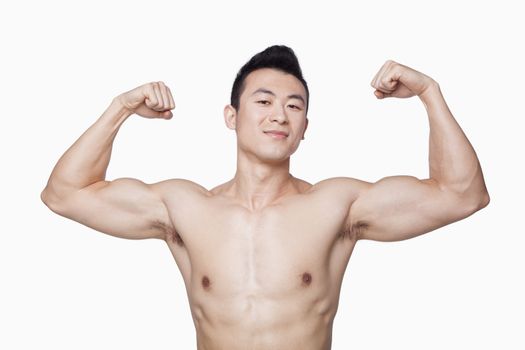 Young man showing off biceps