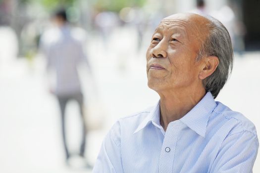 Portrait of smiling senior man, outdoors in Beijing 