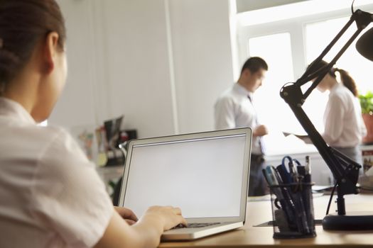 Woman working on her laptop in the office 