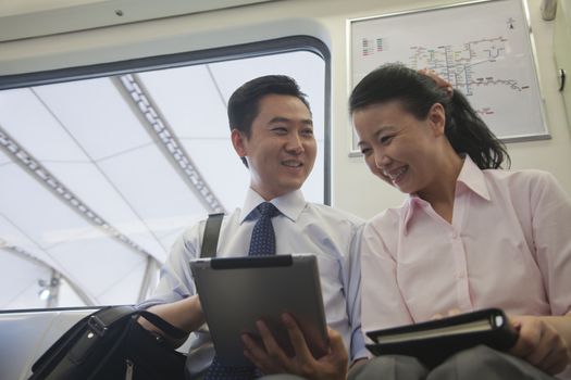 business couple working in the subway 