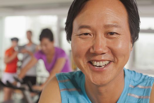 Man smiling and exercising on the exercise bike 