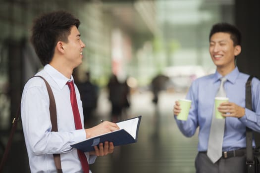 Two young businessmen meeting outdoor