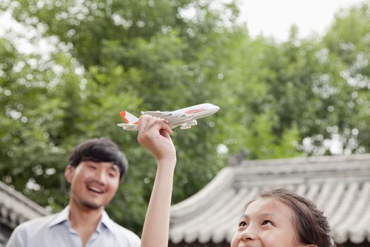 Girl Playing with Airplane