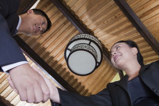 Low Angle View of Businesspeople Shaking Hands