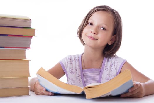 Pretty girl with pile of books isolated over white