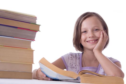 Smiling girl with pile of books isolated on white