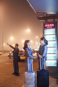 Young business people waiting for a taxi