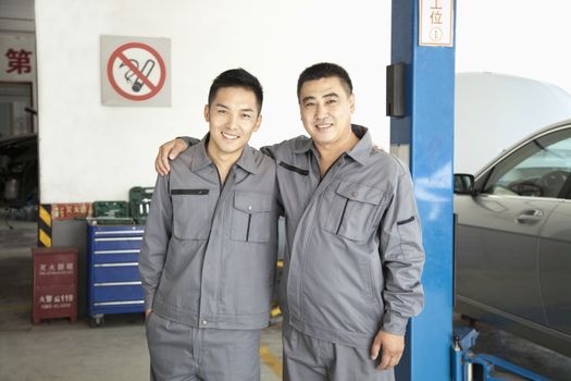 Portrait of Two Garage Mechanics