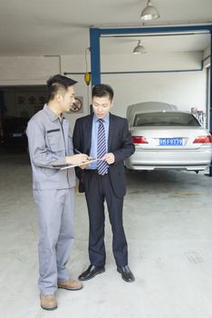 Garage Mechanic Explaining to Customer