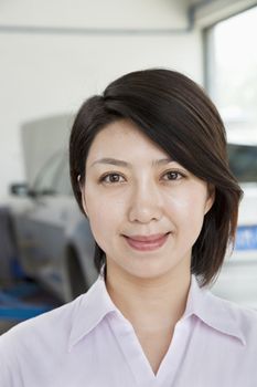 Portrait of Businesswoman at Car Repair Garage