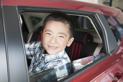 Young Boy Looking Out a Car Window