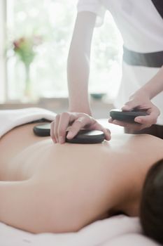 Woman Receiving Hot Stone Massage