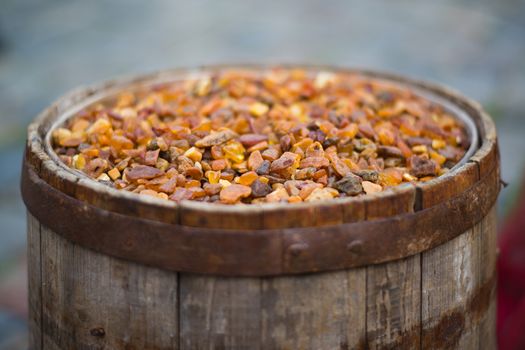 old barrel filled with amber - shallow depth of field
