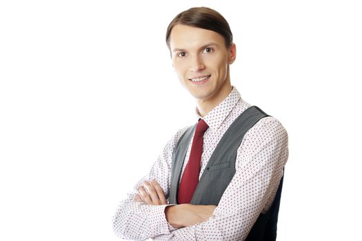 Young smiling teacher or trainer with arms crossed on a white background