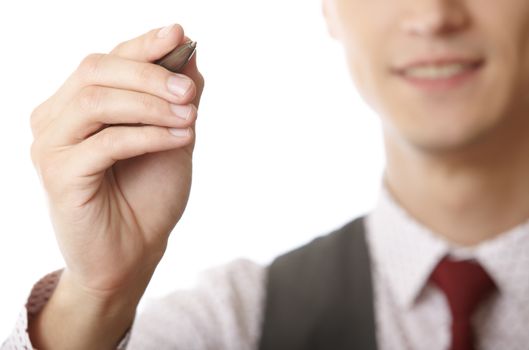 Young smiling businessman is writing on a virtual whiteboard. Focus is on the hand and pen