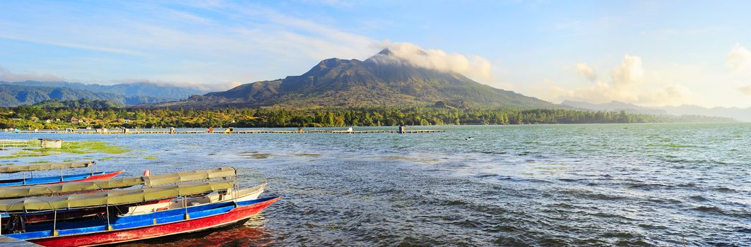 Fishing boats in front of volcano Batur at sunset