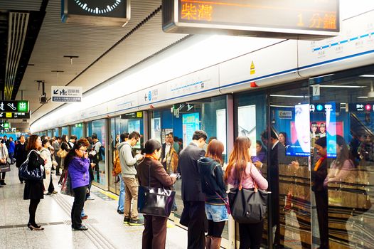 Hong Kong, Hong Kong S.A.R. - January 21, 2013: Unidentified people waiting for a subway train . In 2012 the MTR reportedly had 46.4% of the public transport market, making it the most popular transport in Hong Kong.