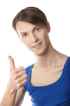 Young fitness instructor making thumbs up gesture on a white background