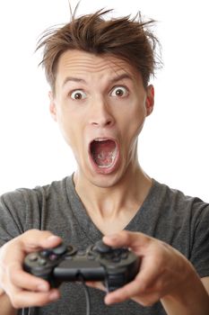Young crazy man plays computer game with joystick