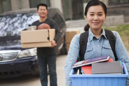 Student portrait in front of dormitory at college