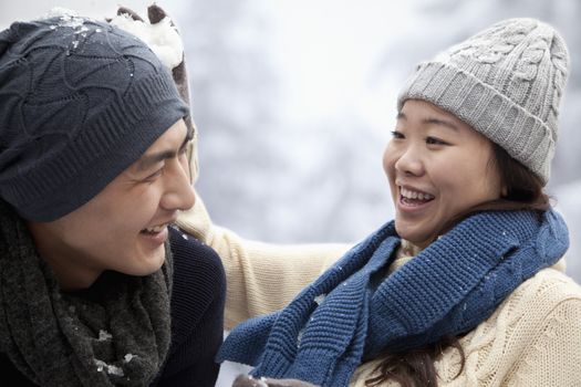 Young Couple Having a Snowball Fight