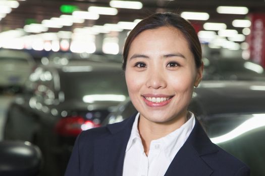 Traveler smiling portrait in airport parking lot