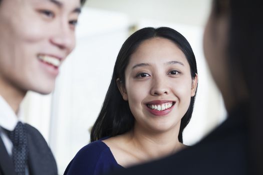 Co-workers talking in office