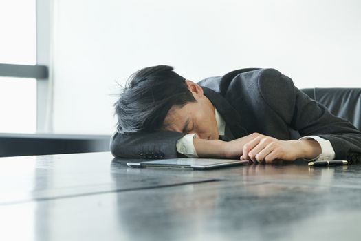 Businessman sleeping in office room