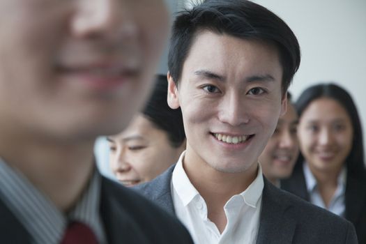 Businessman with co-workers in office portrait