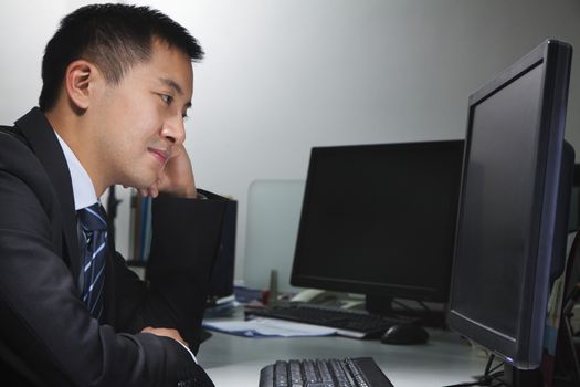 White-collar worker sitting in front of computer in office