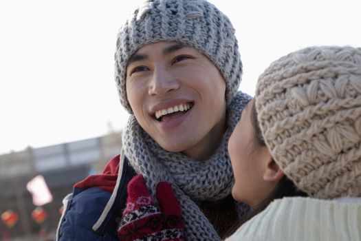 Young couple skating at ice rink