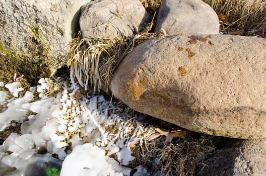 large stones beautifully lit icy grass