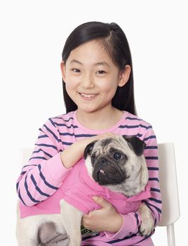 Portrait of girl holding pet pug