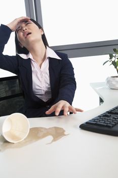 Businesswoman spilling coffee