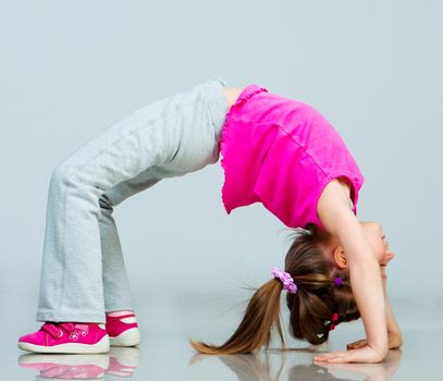Little girl doing gymnastics exercise