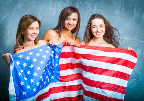 fashion girls with usa flag against textured wall