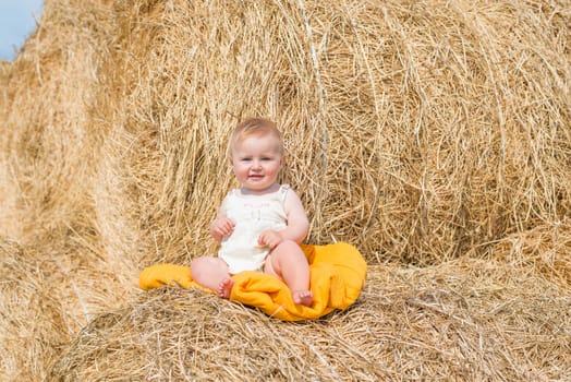 cute baby on stack of hay