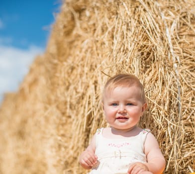 cute baby on stack of hay