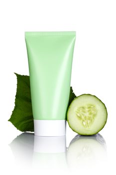 Face mask tube with fresh cucumber slices and leaf on white background. Macro shot