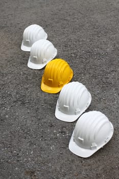 row of white and yellow helmets