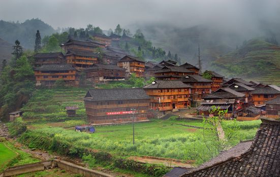 GUANGXI PROVINCE, CHINA - APRIL 3: The village of ethnic Yao, National Minorities in China, Yao village Dazhai, Southwest China, April 3, 2010. Wooden houses on hillside, Dazhai, near Longsheng, Guangxi, China. Yao minoritys home