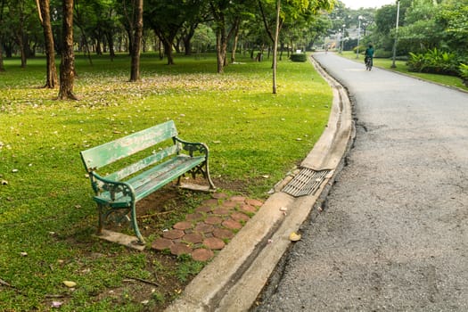 Green bench in the park and streets.