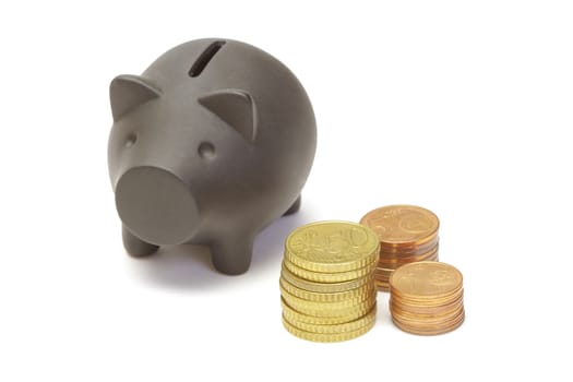 Black piggy bank and coins on white